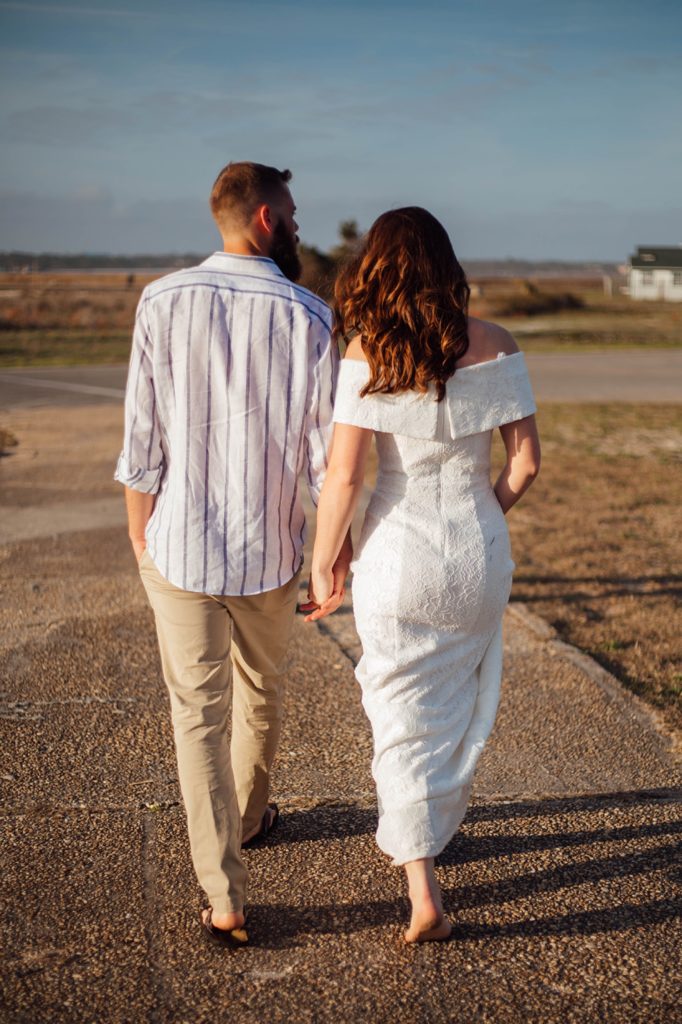 bride and groom elopement walking to the beach